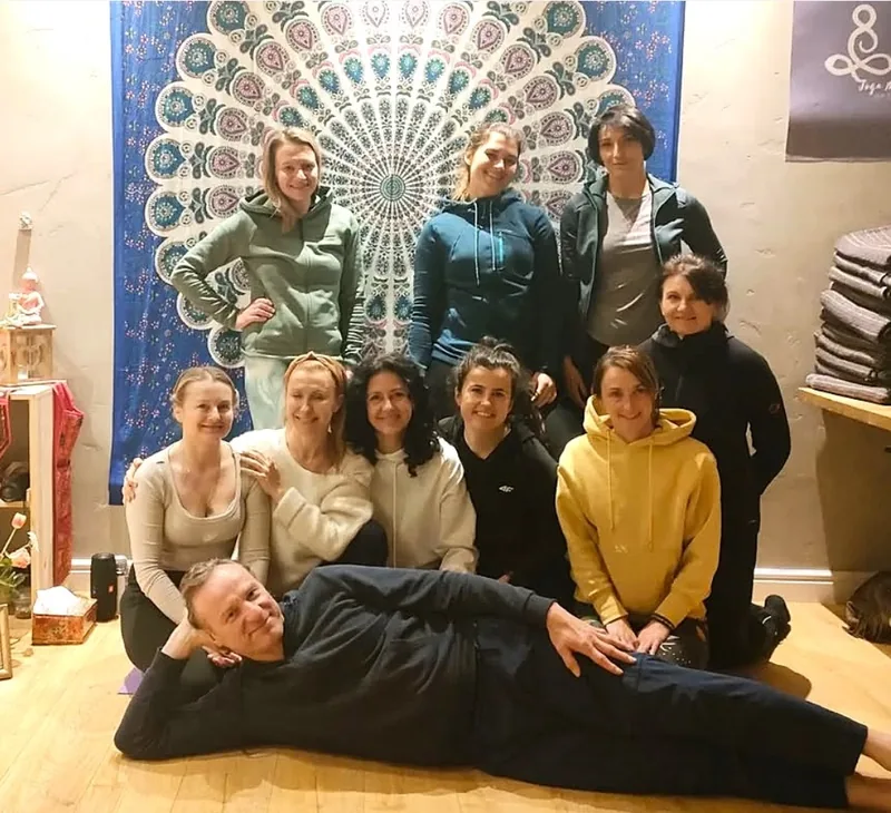 A group after class in the yoga room